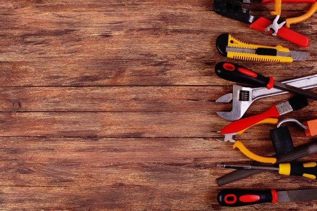 construction-tools-with-copy-space-on-a-wood-background_222342-84